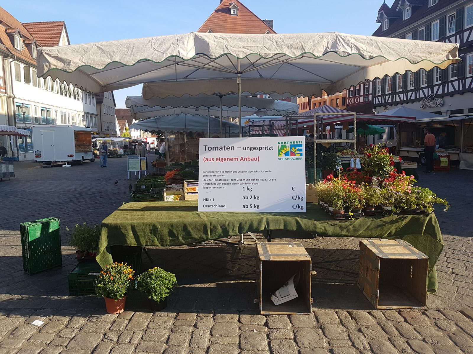 Stand der Gärtnerei Schanbacher auf dem Schorndorfer Wochenmarkt mit Schild „Tomaten aus eigenem Anbau